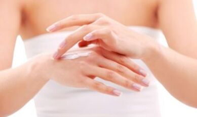 the girl applied ointment to her hand